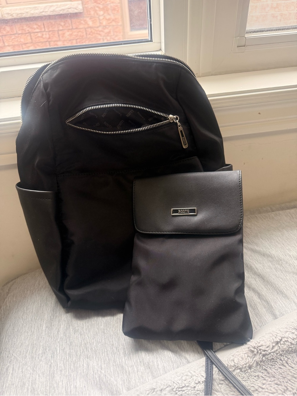 Roots Black Nylon  Backpack with Front Pouch.